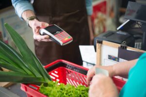 Shopper using a grocery store loyalty card at checkout