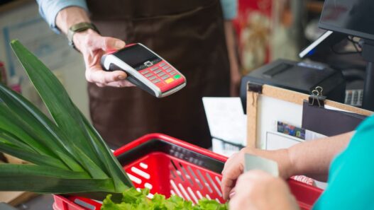 Shopper using a grocery store loyalty card at checkout