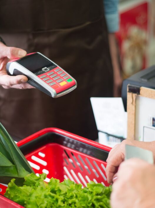 Shopper using a grocery store loyalty card at checkout