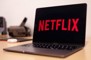 Person reviewing streaming and subscription charges on a laptop to cancel unused subscriptions