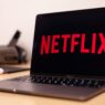 Person reviewing streaming and subscription charges on a laptop to cancel unused subscriptions