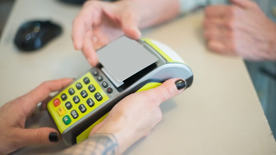 Customer paying with a credit card at a store checkout terminal