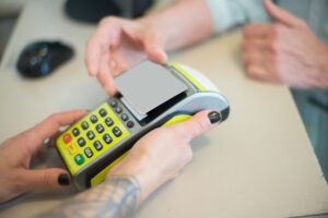 Customer paying with a credit card at a store checkout terminal
