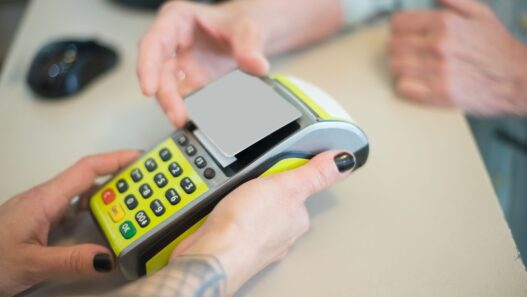 Customer paying with a credit card at a store checkout terminal
