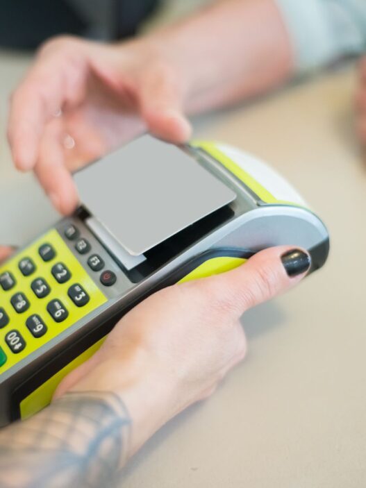 Customer paying with a credit card at a store checkout terminal