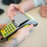 Customer paying with a credit card at a store checkout terminal