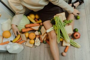 Fresh and leftover produce in a kitchen, illustrating how reducing food waste saves money