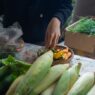 Fresh seasonal produce displayed at a farmers market stall