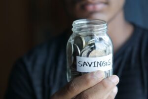 A savings jar filled with coins representing money kept separate for saving