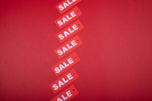 Store sale tags and discount signs representing Labor Day shopping deals