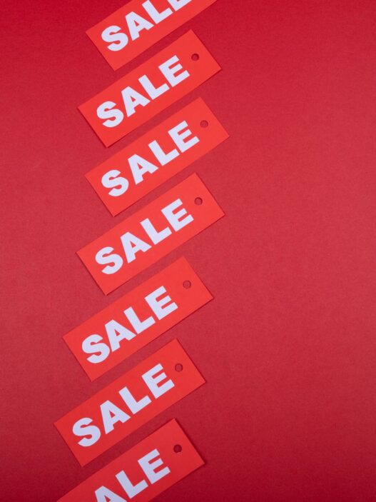 Store sale tags and discount signs representing Labor Day shopping deals