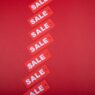 Store sale tags and discount signs representing Labor Day shopping deals