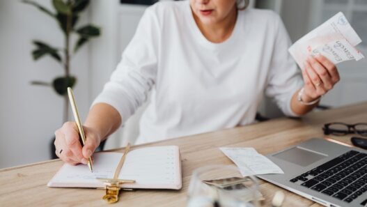 Calendar and cash on a desk, illustrating annual versus monthly bill payments
