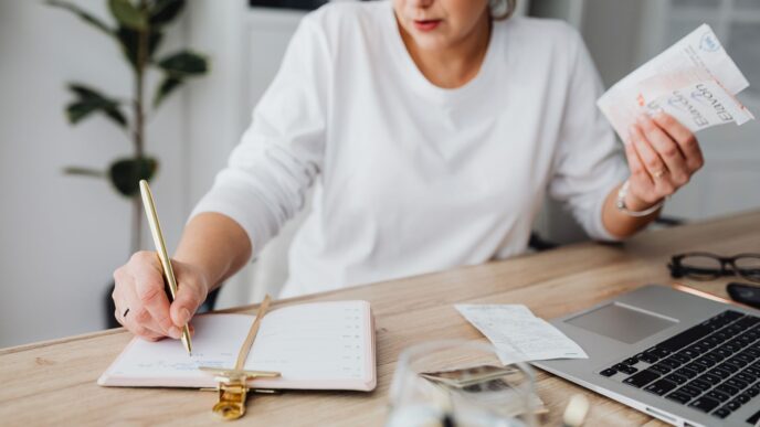 Calendar and cash on a desk, illustrating annual versus monthly bill payments