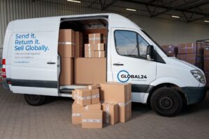 A person packing a cardboard shipping box to return an online order