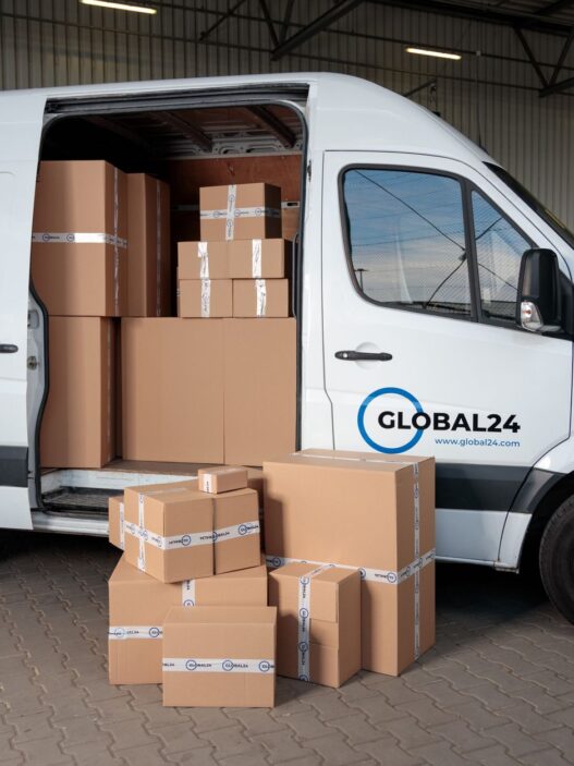 A person packing a cardboard shipping box to return an online order