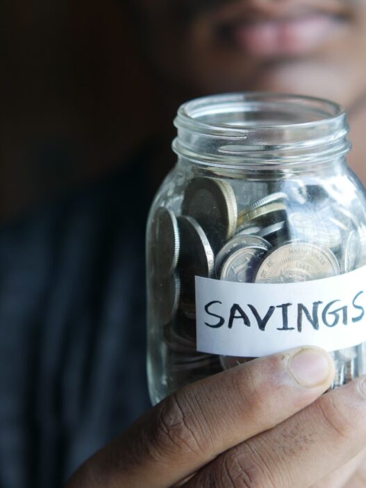 Jar of coins representing round-up savings from spare change
