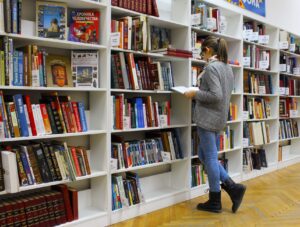 College student studying with textbooks in a library