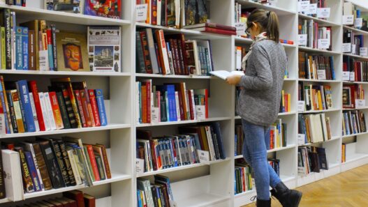 College student studying with textbooks in a library