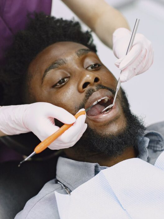 A dental patient at a checkup, illustrating ways to save on dental care without insurance in 2026