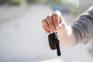 Person receiving car keys at a rental car counter