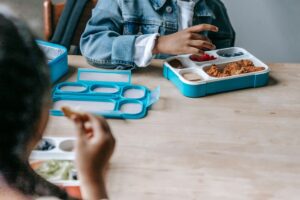 Packed school lunch box with sandwich and fruit