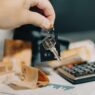 Roommates reviewing shared household bills and expenses together at a table