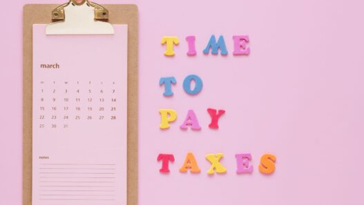 Person planning monthly bills on a calendar with a notebook and calculator