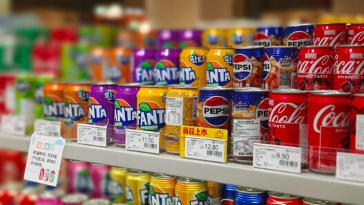 A shopper comparing prices on a grocery store shelf, illustrating how to use unit pricing to save money