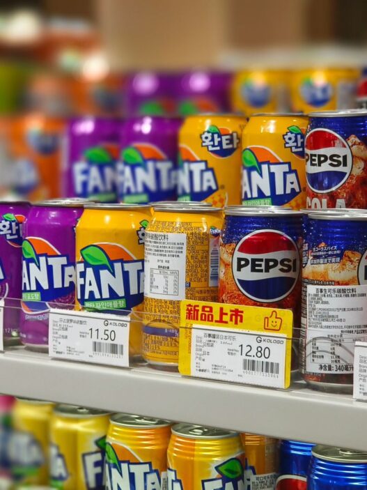 A shopper comparing prices on a grocery store shelf, illustrating how to use unit pricing to save money