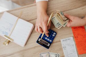 Person reviewing a utility bill and budgeting monthly payments at home