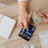 Person reviewing a utility bill and budgeting monthly payments at home