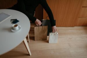 Credit card held beside holiday shopping bags, illustrating quarterly 5% cash back categories