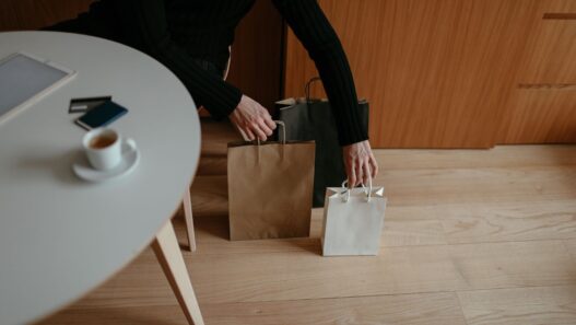 Credit card held beside holiday shopping bags, illustrating quarterly 5% cash back categories