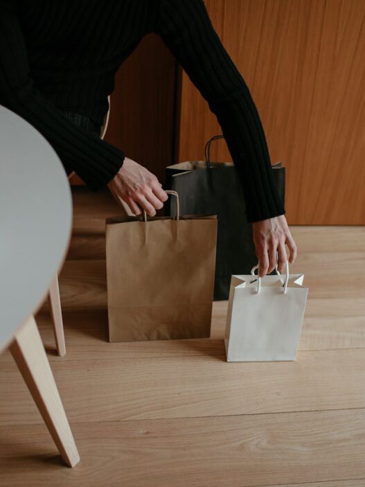 Credit card held beside holiday shopping bags, illustrating quarterly 5% cash back categories