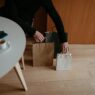 Credit card held beside holiday shopping bags, illustrating quarterly 5% cash back categories