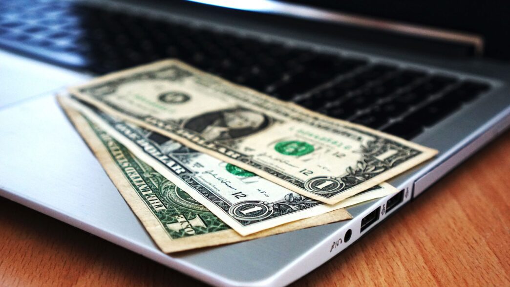 Person reviewing automatic bill payments on a laptop