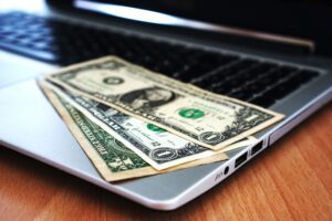 Person reviewing automatic bill payments on a laptop