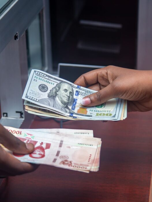Cash and a bank card on a counter, illustrating a checking account sign-up bonus