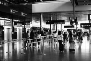 Travelers with luggage in an airport terminal during the holiday travel season