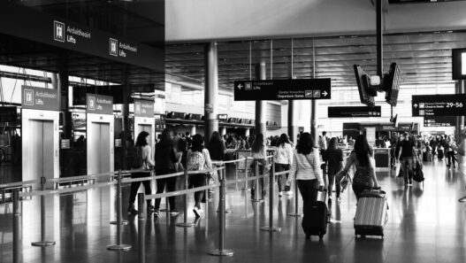 Travelers with luggage in an airport terminal during the holiday travel season