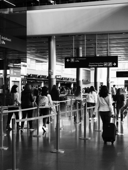 Travelers with luggage in an airport terminal during the holiday travel season