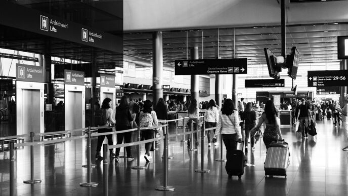 Travelers with luggage in an airport terminal during the holiday travel season