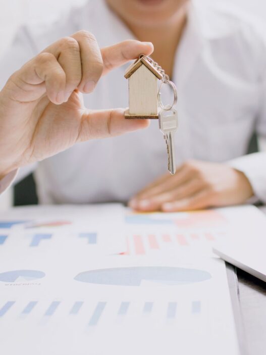 Car insurance paperwork and keys on a desk while reviewing a renewal notice