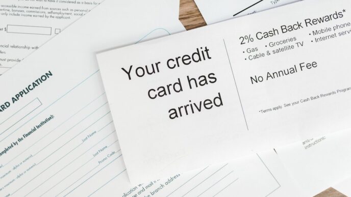 Credit cards and bills on a desk next to a calculator and budget notes