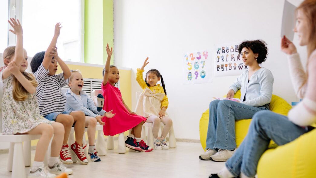 Young children and a caregiver in a daycare classroom