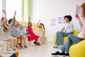 Young children and a caregiver in a daycare classroom
