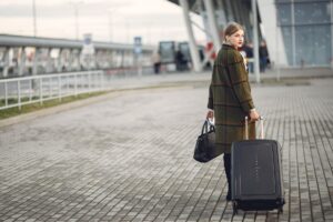 Traveler with luggage at an airport in autumn