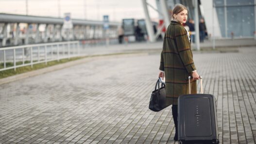 Traveler with luggage at an airport in autumn