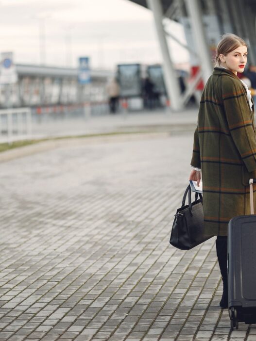 Traveler with luggage at an airport in autumn